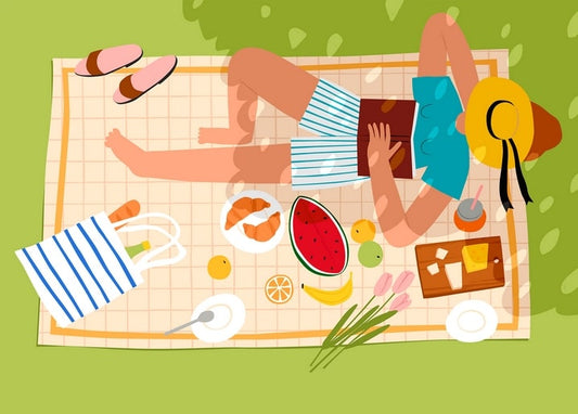 Illustrated woman reading on a picnic blanket with watermelon, croissants, and tulips