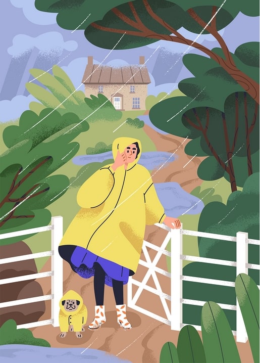 Woman and small dog in matching yellow raincoats standing at a garden gate in the rain