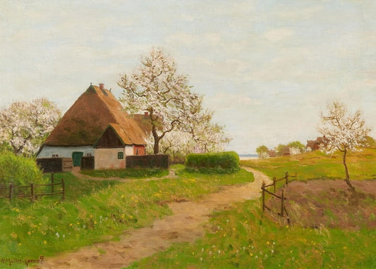 Thatched farmhouse with blossoming trees on the Saaler Bodden
