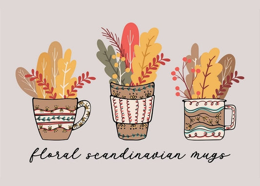 Three folk-patterned Scandinavian mugs filled with autumn leaf and berry bouquets