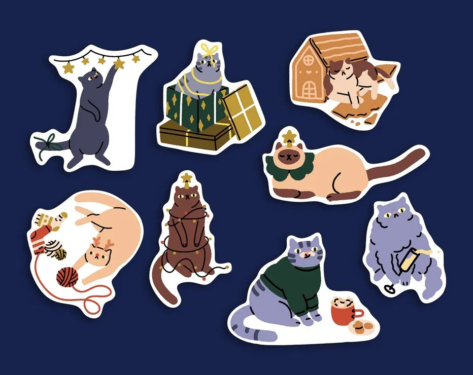 Set of 8 Christmas cat shaped postcards featuring playful cats, holiday gifts, winter sweaters, knitting and cozy festive scenes on a navy blue background.
