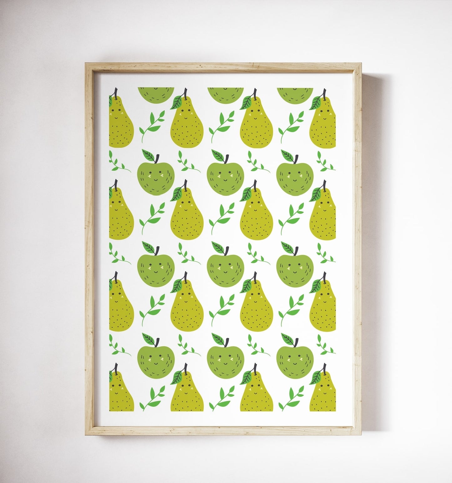 Framed poster of smiling green apples and pears in a repeating pattern on a white wall