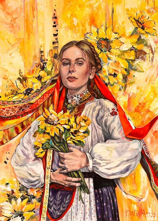 Woman in Ukrainian folk dress holding sunflowers against a golden autumn background