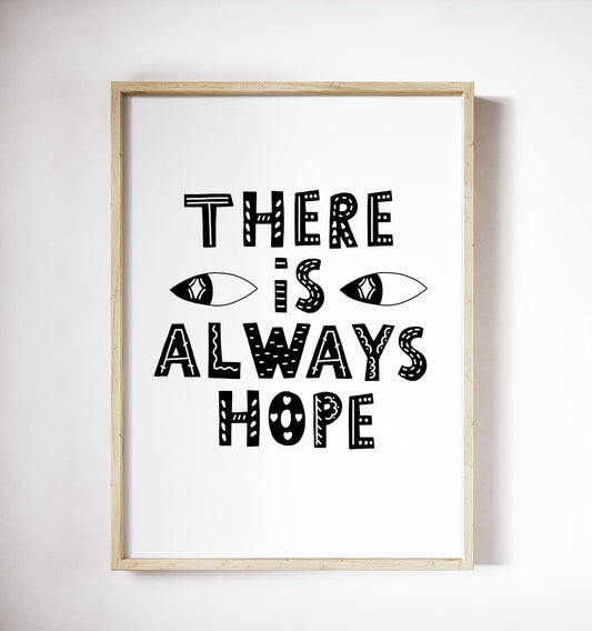 Black-and-white ‘There is always hope’ typography poster in a wood frame on a white wall