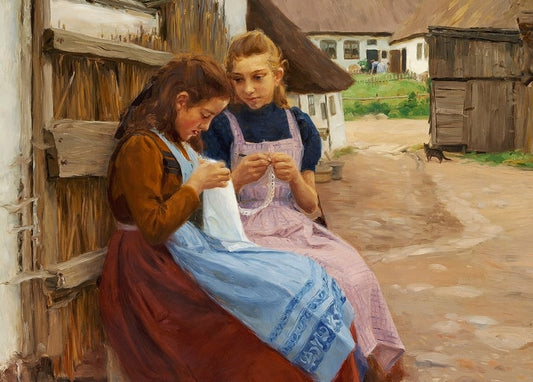 Two girls in Danish dress sewing against a barn wall with a black cat nearby