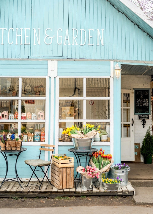 Turquoise ‘Kitchen & Garden’ café at Kyiv's VDNG with buckets of spring tulips and daffodils