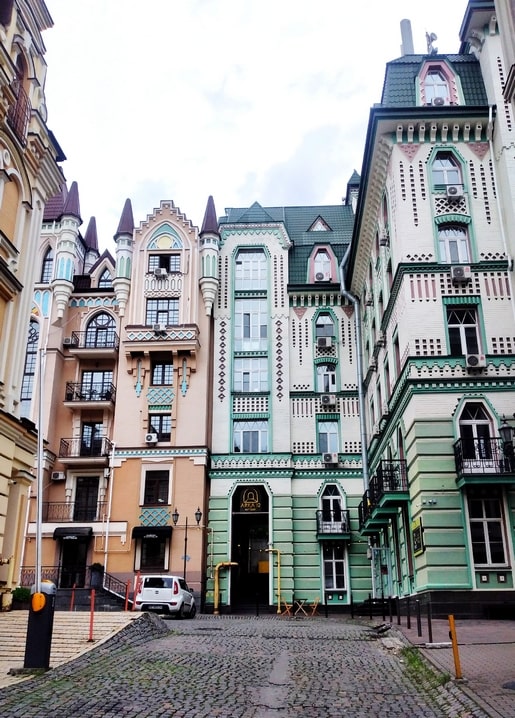 Turquoise, peach and cream fairy-tale facades on a cobblestone street, Vozdvizhenka, Kyiv