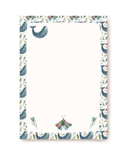 Watercolor border of blue whales, moths and flowers framing blank cream letter paper