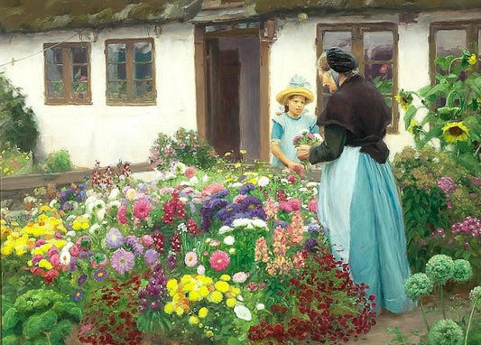 Woman handing flowers to a girl in a straw hat among dahlias and zinnias in a cottage garden