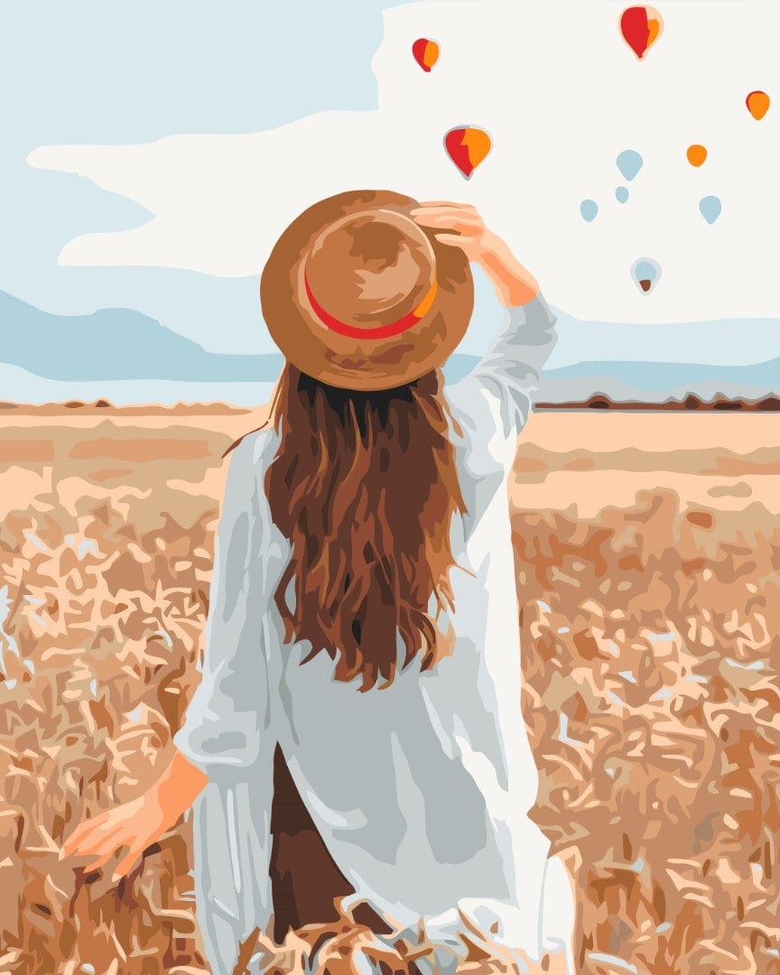 Frau von hinten mit Hut geht durch ein goldenes Roggenfeld, am Himmel Heißluftballons, Malen-nach-Zahlen-Bild