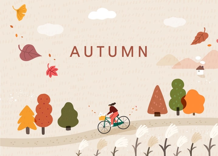 Illustrated woman cycling past autumn trees and a hillside village with falling leaves