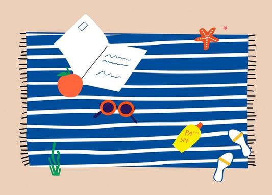 Striped beach towel with a postcard, pen, sunglasses, sunscreen, an orange, and a starfish