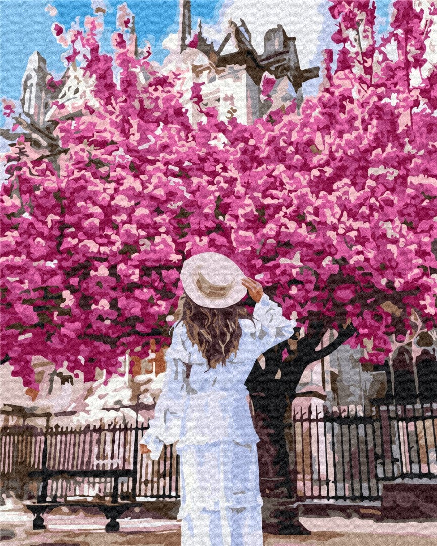 Woman in white before a blooming pink tree with Notre Dame de Paris behind, paint-by-numbers by Tany Moko