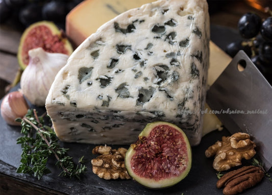 Wedge of blue cheese with figs, walnuts and garlic on dark slate