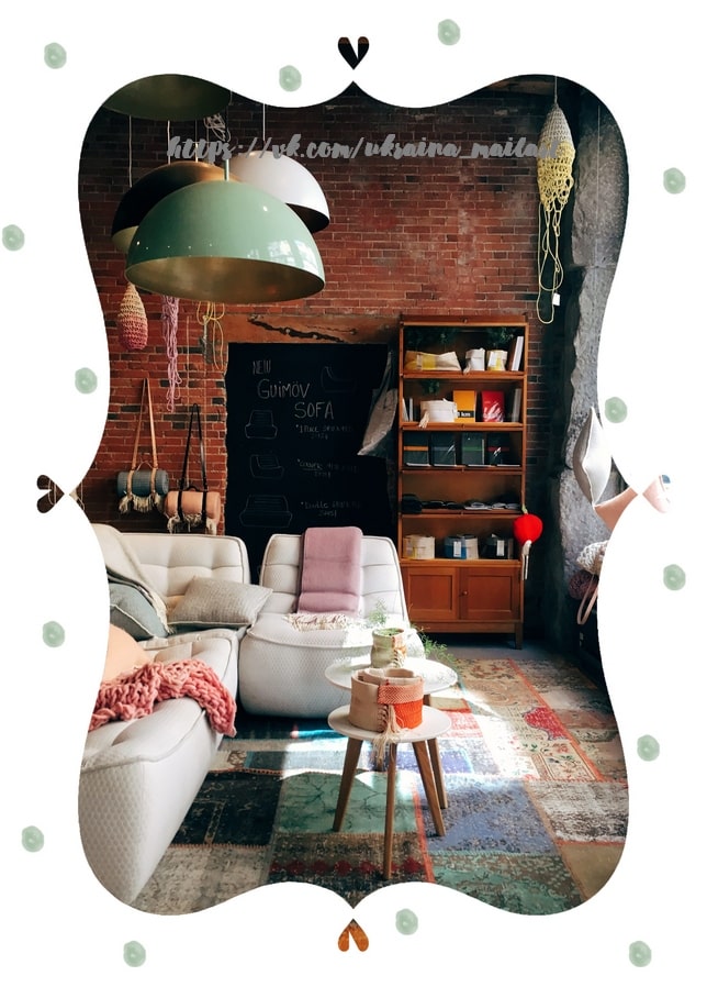 Cozy boho loft living room with brick wall, pendant lamps, and a white sofa