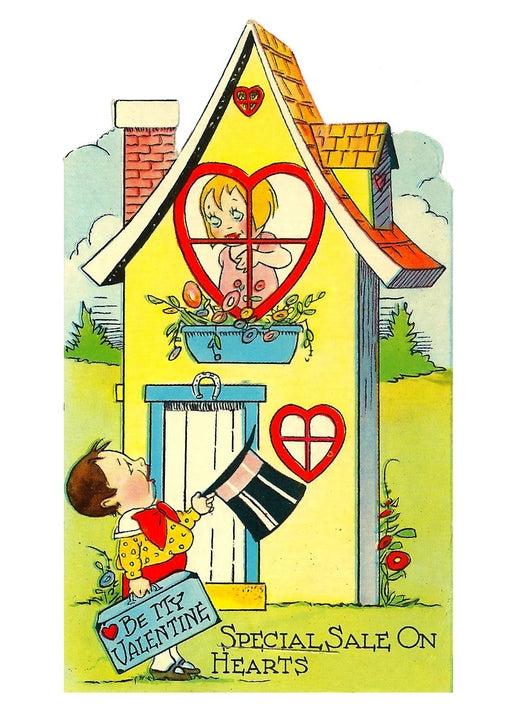 Vintage postcard of a boy holding a 'Be My Valentine' sign outside a cottage with heart-shaped windows.