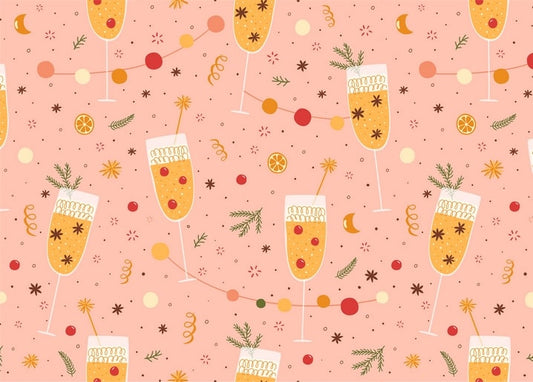 Champagne flutes, confetti garlands, orange slices and rosemary sprigs on pink