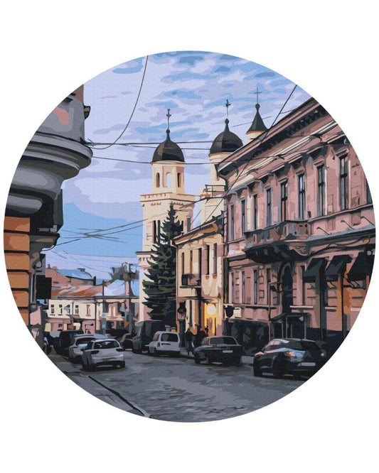 Pastel townhouses and a domed cathedral at dusk on a round paint-by-numbers canvas, design by Oksana Ermoshenko