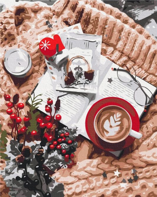 Draufsicht: Herz-Latte, Buch, roter Fäustling und Stechpalme auf einer Strickdecke