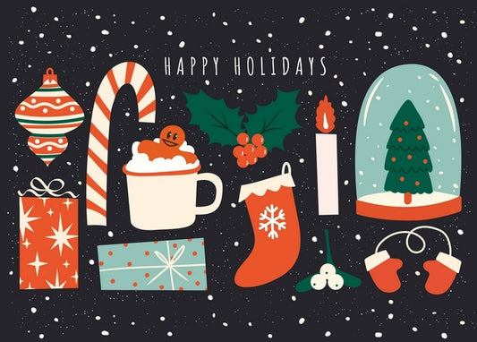 Flat lay of Christmas ornaments, cocoa, candy cane and a snow globe on a dark snowy background