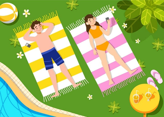Man and woman relaxing on striped towels by a pool with a beach ball and drinks
