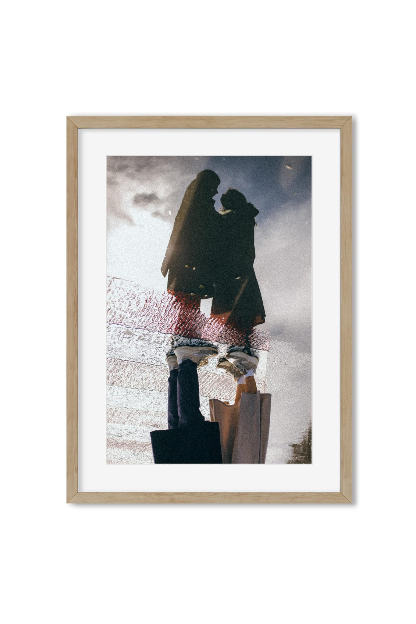 Reflection photography poster showing an embracing couple mirrored in a rain puddle