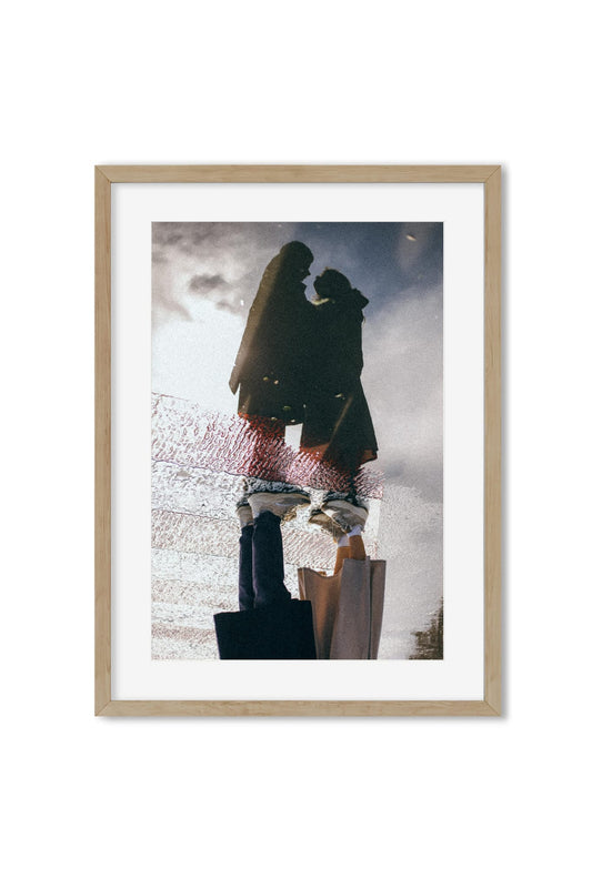 Reflection photography poster showing an embracing couple mirrored in a rain puddle