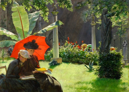 Two women under a red parasol read together in a park with stone columns and a statue, by Charles Courtney Curran