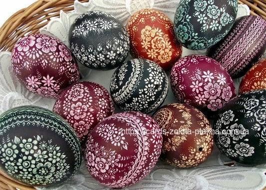 Basket of dark burgundy, black and teal Easter eggs with fine floral patterns