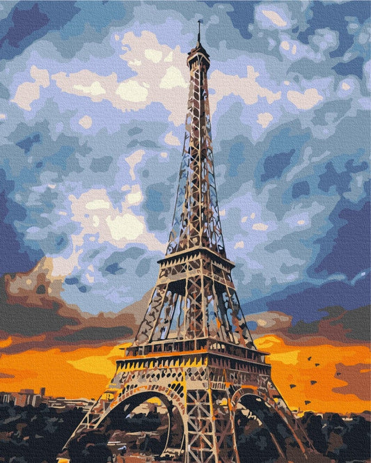 Eiffel Tower silhouette against a fiery orange and blue sunset sky