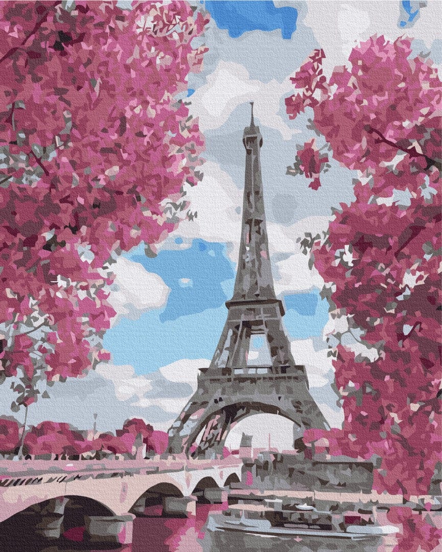 Eiffel Tower framed by pink spring blossoms above the Seine