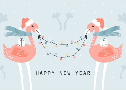 Two pink flamingos in Santa hats holding gift boxes and fairy lights