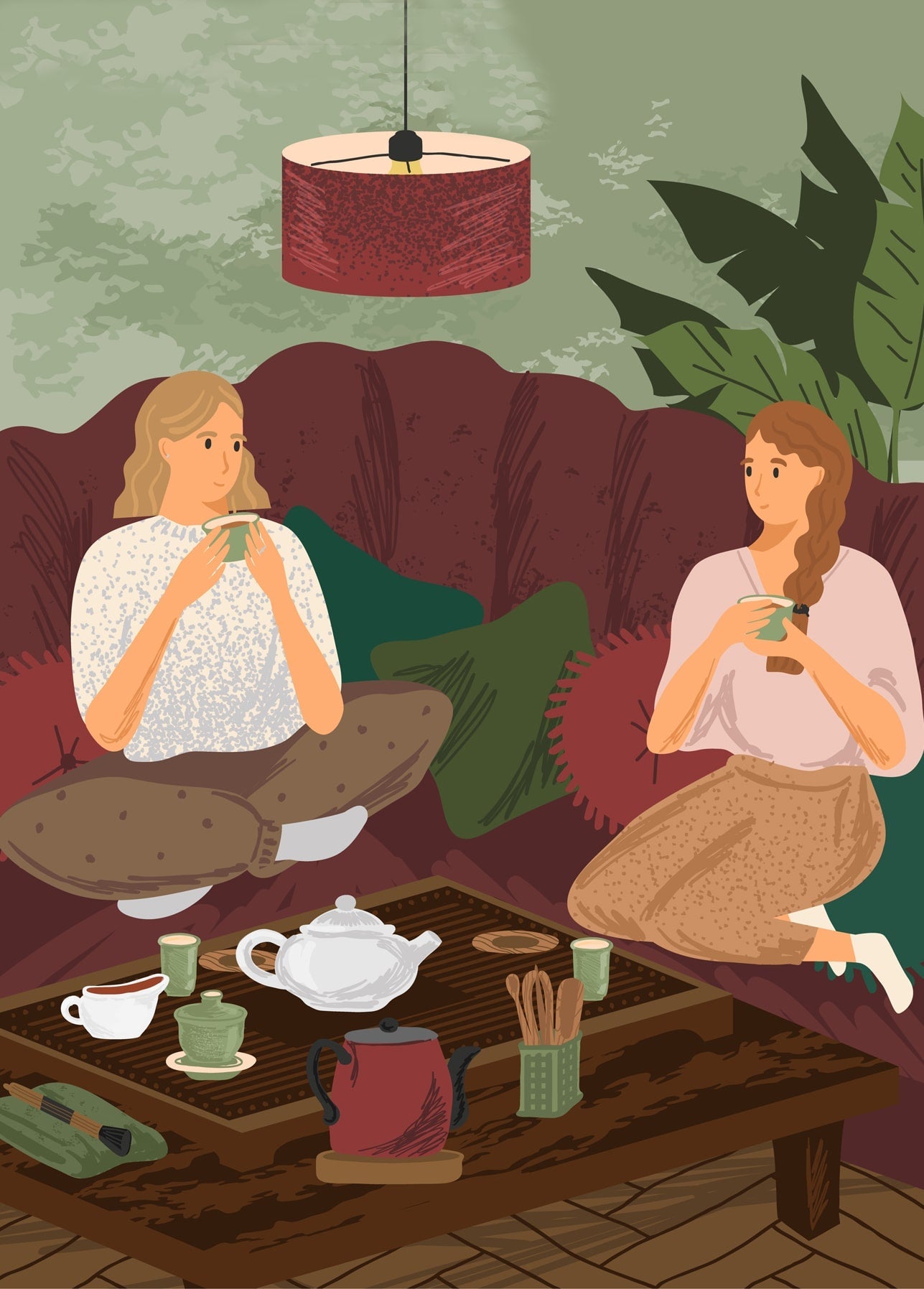Two women sit cross-legged on a red sofa drinking tea, with a tea set on a low table and a red pendant lamp above.