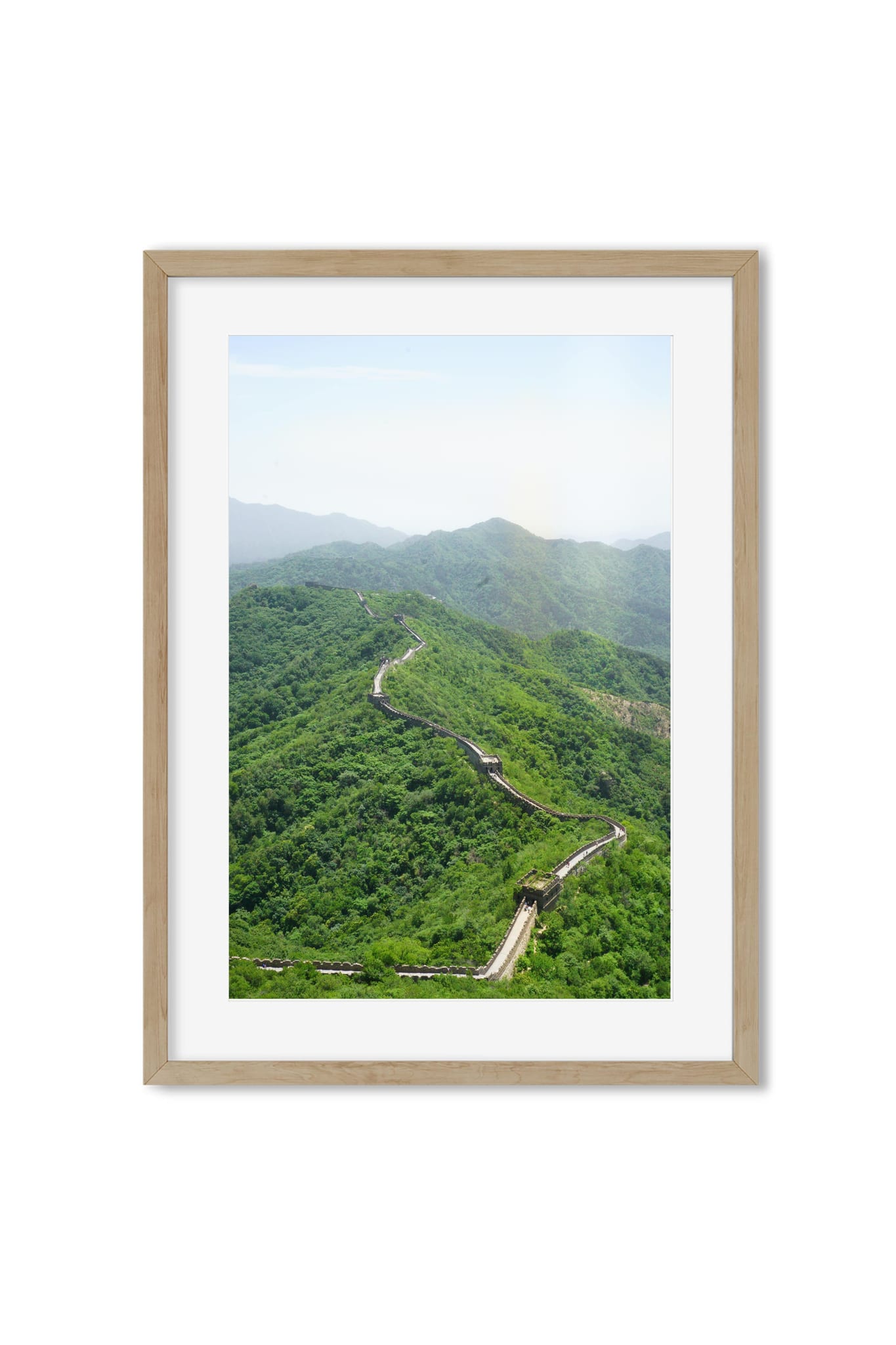 Aerial view of the Great Wall of China crossing a forested mountain ridge