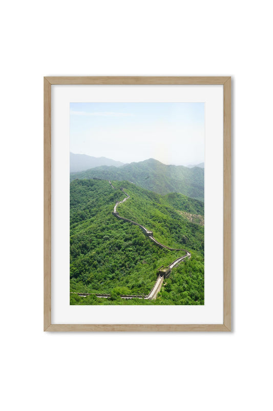 Aerial view of the Great Wall of China crossing a forested mountain ridge