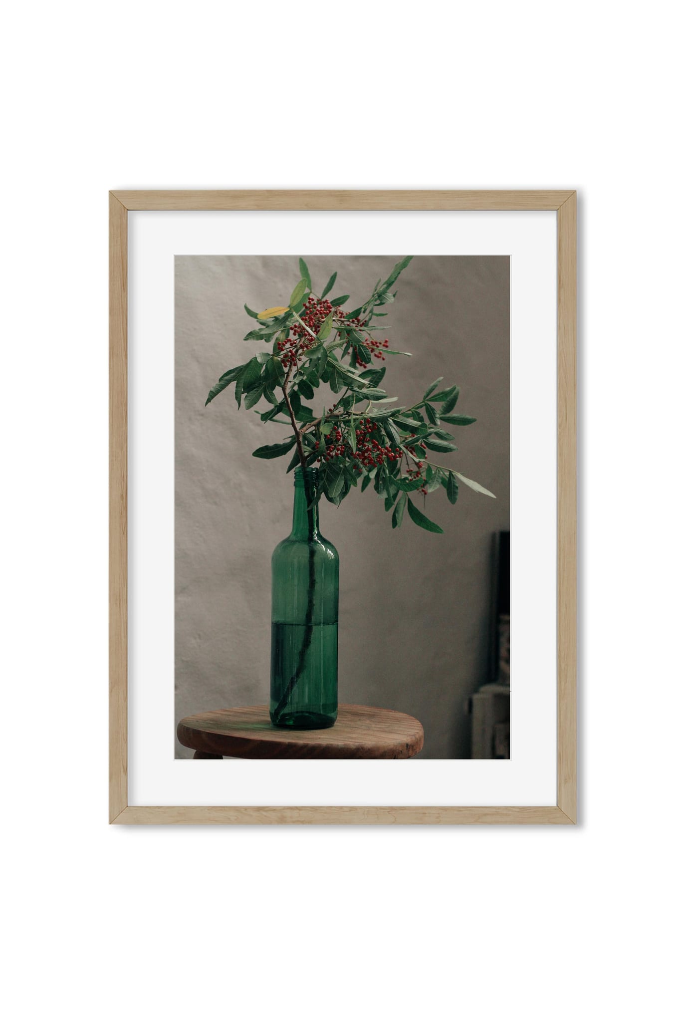 Still life poster of a green glass bottle holding a branch of red berries on a wooden stool