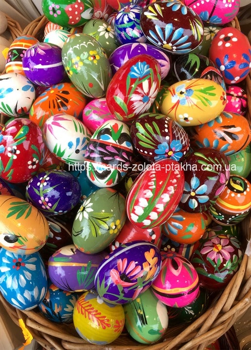 Basket of hand-painted wooden Easter eggs with colorful folk-art floral patterns