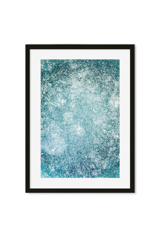 Abstract close-up of an icy blue and white speckled, frosted texture