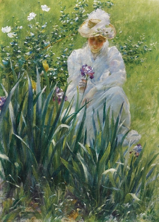 Charles Courtney Curran painting of a woman in a straw hat crouching to pick purple irises in tall garden grass