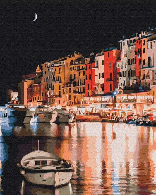 Paint-by-numbers painting of a colorful Italian harbor town under a crescent moon with a boat reflected in the water