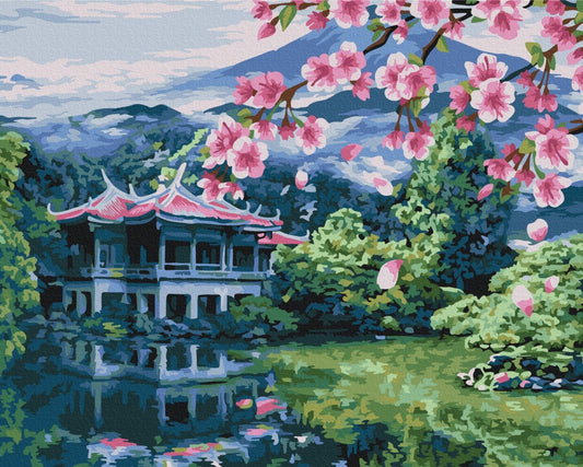 Japanese pavilion reflected in a pond beneath cherry blossoms and misty mountains
