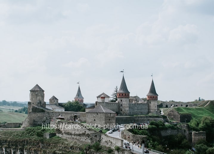 Aerial view of Kamianets-Podilskyi Castle towers above a river canyon in Ukraine