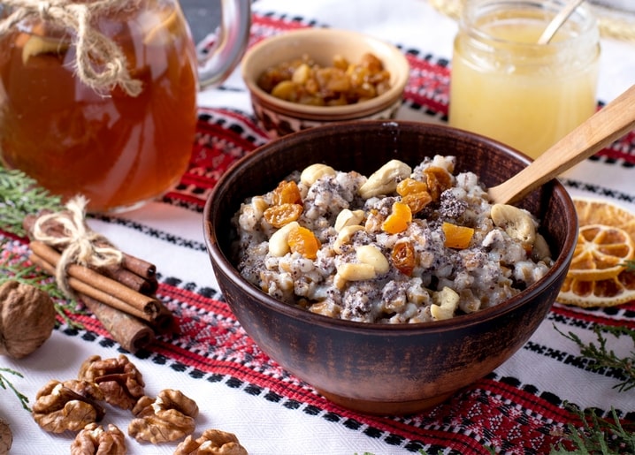 Bowl of kutia with honey, walnuts and dried fruit on an embroidered Ukrainian rushnyk