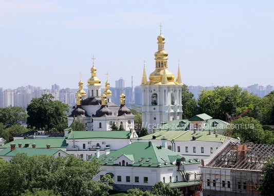 Golden domes and bell tower of Kyiv Pechersk Lavra above green monastery roofs