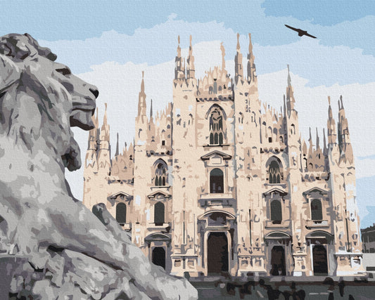 Stone lion statue in front of Milan Cathedral's Gothic spires and a flying bird