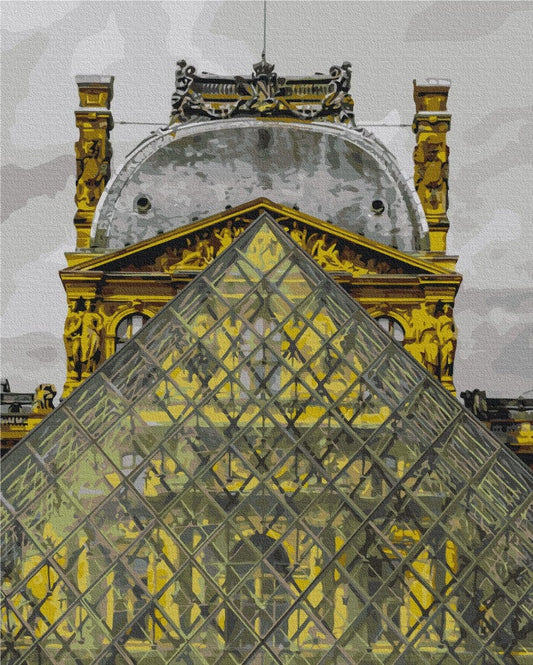 The Louvre's glass pyramid rising against its golden ornate façade and dome