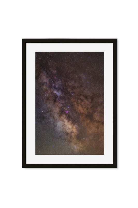 Framed poster of the Milky Way's galactic core amid dense stars and purple nebula clouds