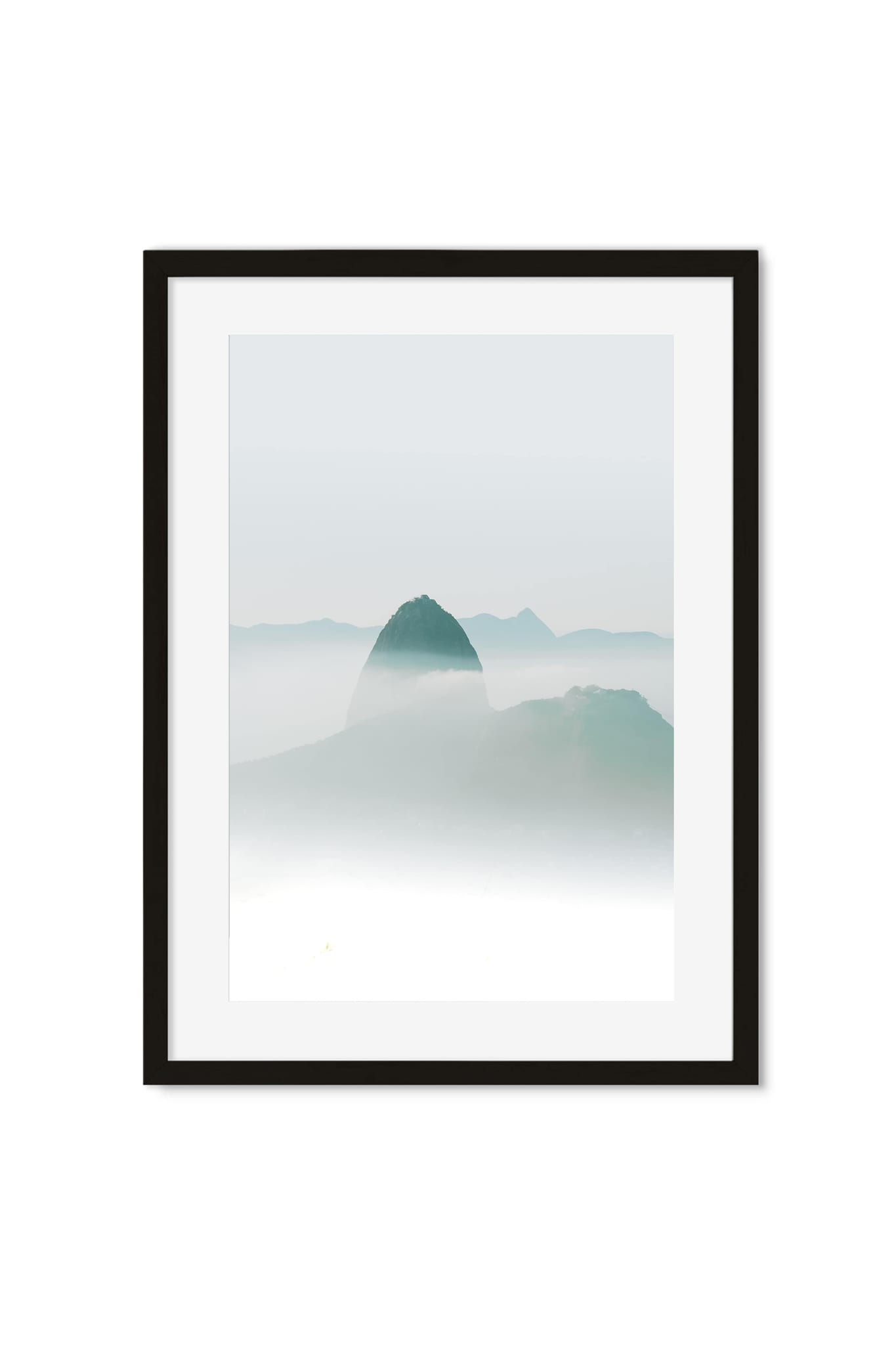 Dark mountain peak rising through a sea of pale teal fog