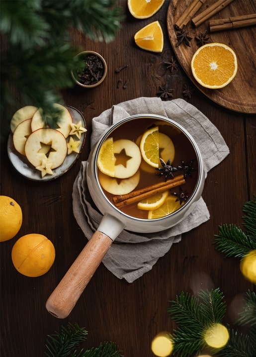 Pot of mulled wine with orange slices, cinnamon, and star anise, top view
