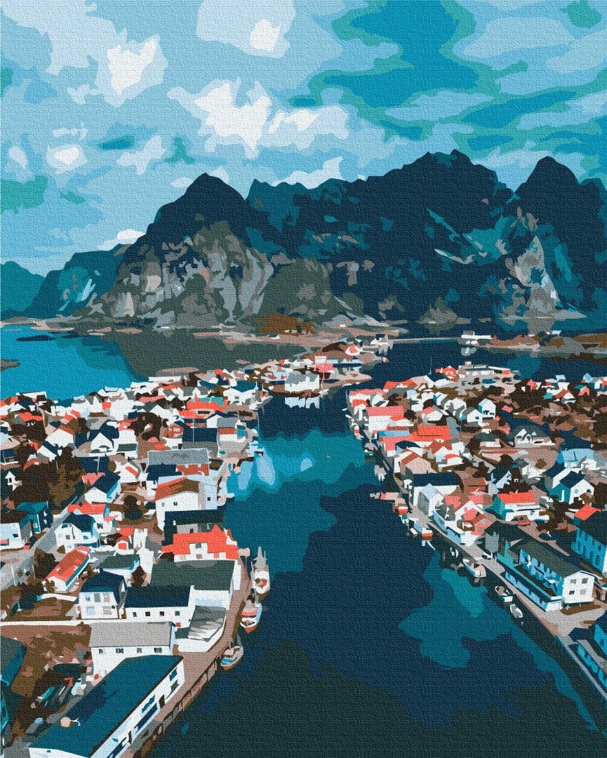 Aerial view of a red and white fishing village on a Norwegian fjord strait